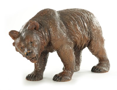 Lot 1337 - A 19TH CENTURY CARVED LINDEN WOOD BLACK FOREST BEAR