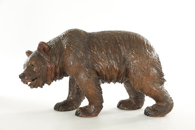 Lot 1337 - A 19TH CENTURY CARVED LINDEN WOOD BLACK FOREST BEAR