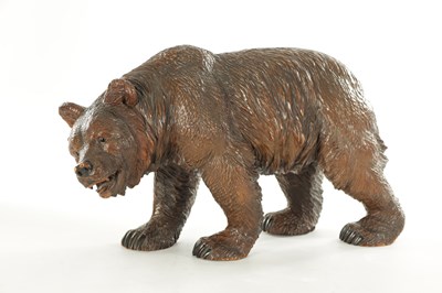 Lot 1337 - A 19TH CENTURY CARVED LINDEN WOOD BLACK FOREST BEAR