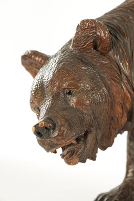 Lot 1337 - A 19TH CENTURY CARVED LINDEN WOOD BLACK FOREST BEAR