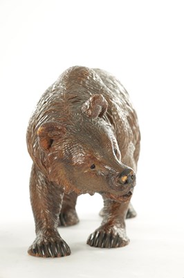 Lot 1337 - A 19TH CENTURY CARVED LINDEN WOOD BLACK FOREST BEAR