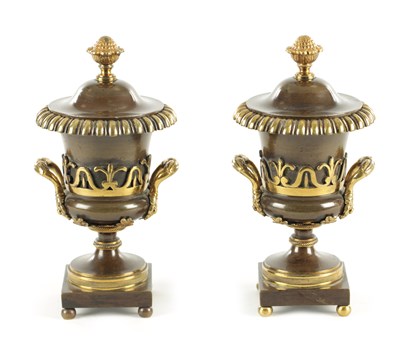 Lot 884 - A PAIR OF REGENCY BRONZE AND GILT BRONZE URN SHAPED CASSOLETTES/CANDLESTICKS