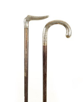 Lot 730 - TWO LATE 19TH CENTURY EXOTIC DENSE HARDWOOD CONTINENTAL SILVER METAL MOUNTED WALKING STICKS