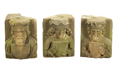 Lot 822 - A SET OF THREE EARLY CARVED STONE HEADS