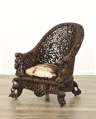 Lot 134 - A 19TH CENTURY CARVED HARDWOOD INDIAN ARMCHAIR