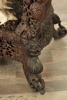 Lot 134 - A 19TH CENTURY CARVED HARDWOOD INDIAN ARMCHAIR