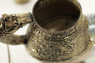 Lot 195 - AN EARLY 20TH CENTURY TIBETAN SILVER METAL AND MOTHER OF PEARL SHELL TEAPOT AND JUG