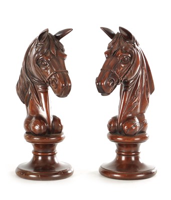 Lot 1331 - A LARGE PAIR OF CARVED MAHOGANY CHESS KNIGHTS