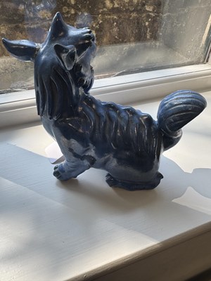 Lot 127 - A 19TH CENTURY CHINESE BLUE GLAZED SEATED FOO DOG