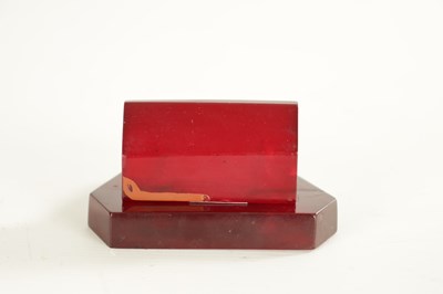 Lot 897 - ART DECO AMBER BAKELITE PEN RESTS