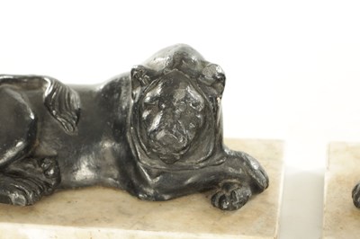 Lot 876 - A PAIR OF REGENCY PAINTED LEAD RECUMBENT LIONS IN THE MANNER OF THOMAS HOPE