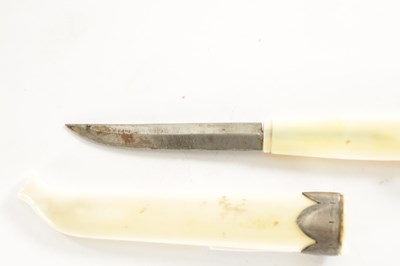Lot 618 - A RARE 19TH CENTURY CARVED WALRUS TOOTH KNIFE