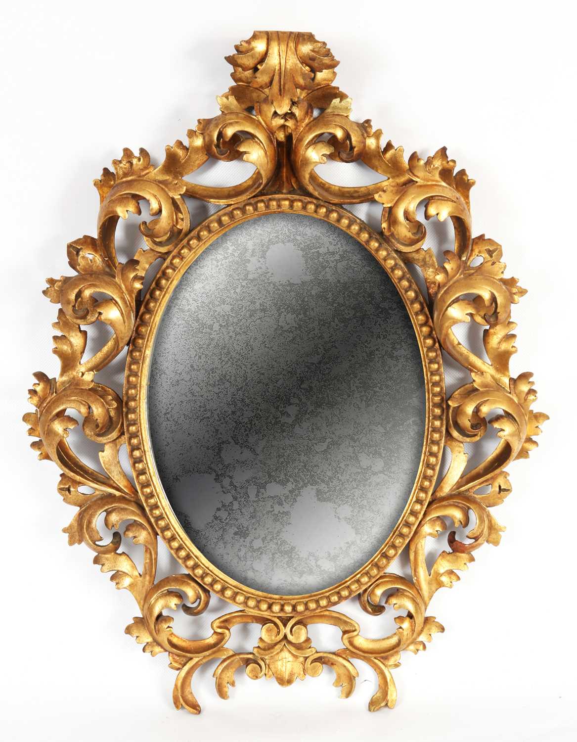 Lot 810 - AN ELABORATE CARVED GILT GESSO FLORENTINE OVAL...