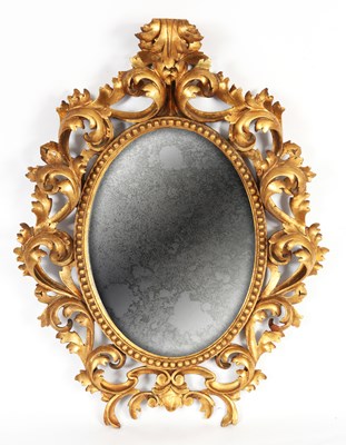 Lot 810 - AN ELABORATE CARVED GILT GESSO FLORENTINE OVAL...