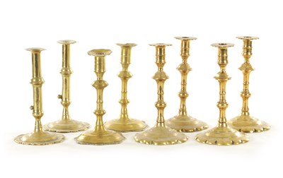 Lot 555 - A COLLECTION OF FOUR PAIRS OF EARLY 18TH CENTURY BRASS CANDLESTICKS