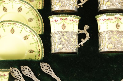 Lot 254 - A CASED ROYAL WORCESTER SIX PIECE COFFEE SERVICE WITH SILVER PLATED CUPHOLDERS AND SPOONS