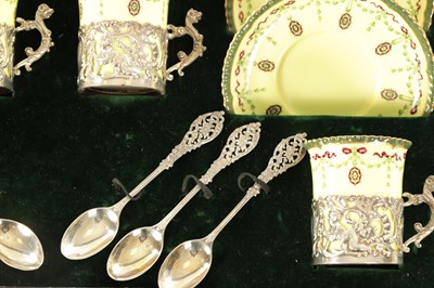 Lot 254 - A CASED ROYAL WORCESTER SIX PIECE COFFEE SERVICE WITH SILVER PLATED CUPHOLDERS AND SPOONS