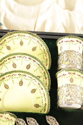 Lot 254 - A CASED ROYAL WORCESTER SIX PIECE COFFEE SERVICE WITH SILVER PLATED CUPHOLDERS AND SPOONS