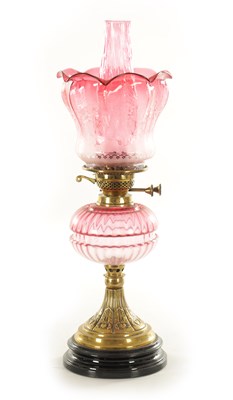 Lot 685 - A GOOD VICTORIAN CRANBERRY GLASS AND BRASS OIL LAMP