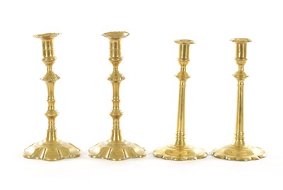 Lot 543 - A GOOD PAIR OF EARLY GEORGIAN PETAAL BASED BRASS CANDLESTICKS