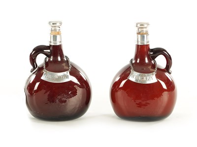 Lot 381 - A PAIR OF LATE GEORGIAN AMBER GLASS AND SILVER MOUNTED SPIRIT FLASKS