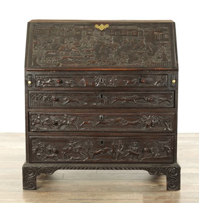 Lot 835 - A GEORGE III CARVED OAK BUREAU