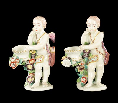 Lot 57 - A PAIR OF MID 18TH CENTURY DERBY CUPIDS WITH BASKETS