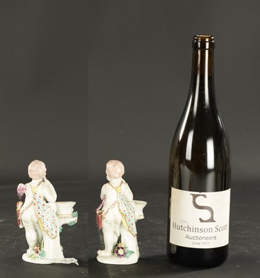 Lot 57 - A PAIR OF MID 18TH CENTURY DERBY CUPIDS WITH BASKETS