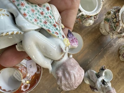 Lot 57 - A PAIR OF MID 18TH CENTURY DERBY CUPIDS WITH BASKETS