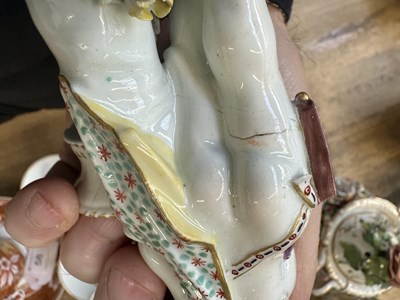 Lot 57 - A PAIR OF MID 18TH CENTURY DERBY CUPIDS WITH BASKETS