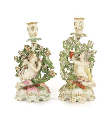 Lot 246 - A PAIR OF MID 18TH CENTURY DERBY CANDLESTICK FIGURES OF CUPID