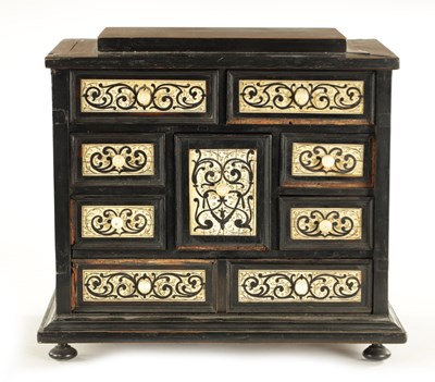 Lot 1188 - A 17TH CENTURY ITALIAN EBONISED AND MARQUETRY INLAID IVORY FRONTED TABLE CABINET