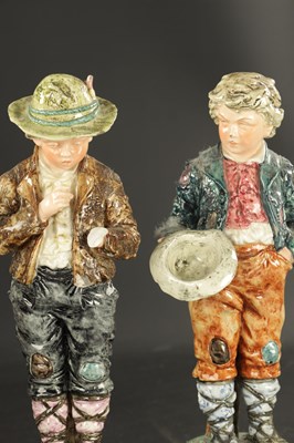 Lot A PAIR OF LATE 19TH CENTURY ROYAL DUX FIGURES OF BOYS