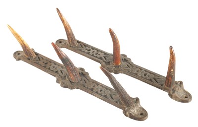 Lot 786 - A PAIR OF LATE 19TH CENTURY CAST IRON AND ANTLER HORN WHIP HOOKS