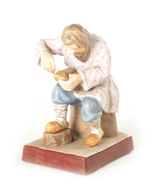 Lot 35 - A RUSSIAN IMPERIAL SEATED FIGURE OF A COBBLER