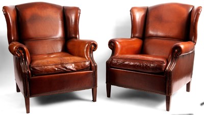 Lot 766 - A pair of Tan Leather WINGBACK ARMCHAIRS of...