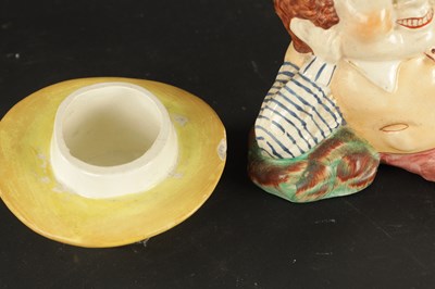 Lot 329 - A STAFFORDSHIRE TABACO JAR IN THE FORM OF A MAN AND A SMALLER SIMILAR EXAMPLE