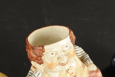 Lot 329 - A STAFFORDSHIRE TABACO JAR IN THE FORM OF A MAN AND A SMALLER SIMILAR EXAMPLE
