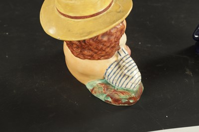 Lot 329 - A STAFFORDSHIRE TABACO JAR IN THE FORM OF A MAN AND A SMALLER SIMILAR EXAMPLE