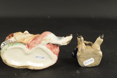 Lot 329 - A STAFFORDSHIRE TABACO JAR IN THE FORM OF A MAN AND A SMALLER SIMILAR EXAMPLE