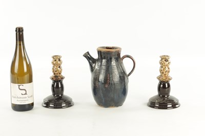 Lot A PAIR OF 19TH CENTURY SLIPWARE CANDLESTICKS AND MATCHING JUG