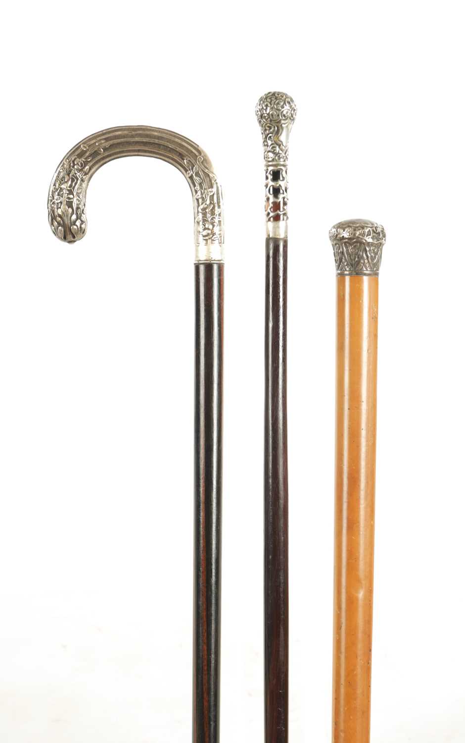 Lot A COLLECTION OF THREE EARLY 20TH CENTURY SILVER MOUNTED WALKING STICKS