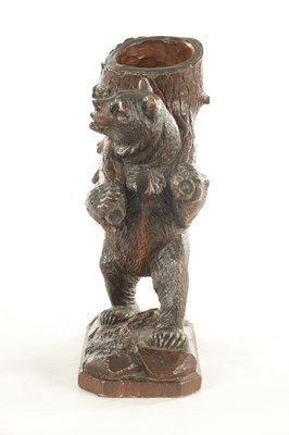 Lot 1155 - A 19TH CENTURY BLACK FOREST CARVED LINDEN WOOD BEAR DECANTER STAND