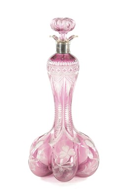 Lot 26 - AN EARLY 20TH CENTURY SILVER TOPPED INTAGLIO CUT GLASS PINK TINTED DECANTER