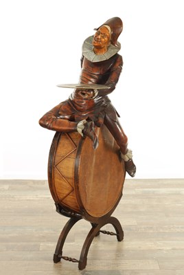 Lot 796 - A 19TH CENTURY CARVED WALNUT HARLEQUIN SEATED ON A DRUM