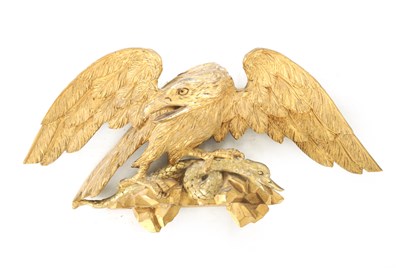 Lot 1170 - A REGENCY CARVED GILT-WOOD EAGLE WITH SERPENT