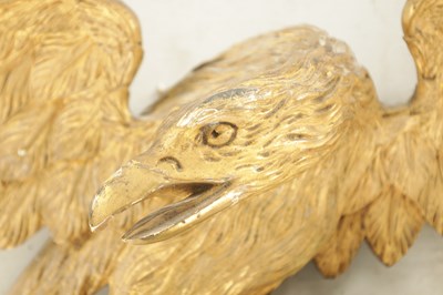 Lot 1170 - A REGENCY CARVED GILT-WOOD EAGLE WITH SERPENT