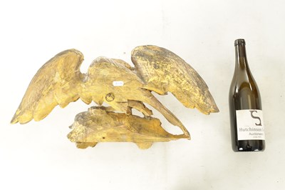 Lot 1170 - A REGENCY CARVED GILT-WOOD EAGLE WITH SERPENT
