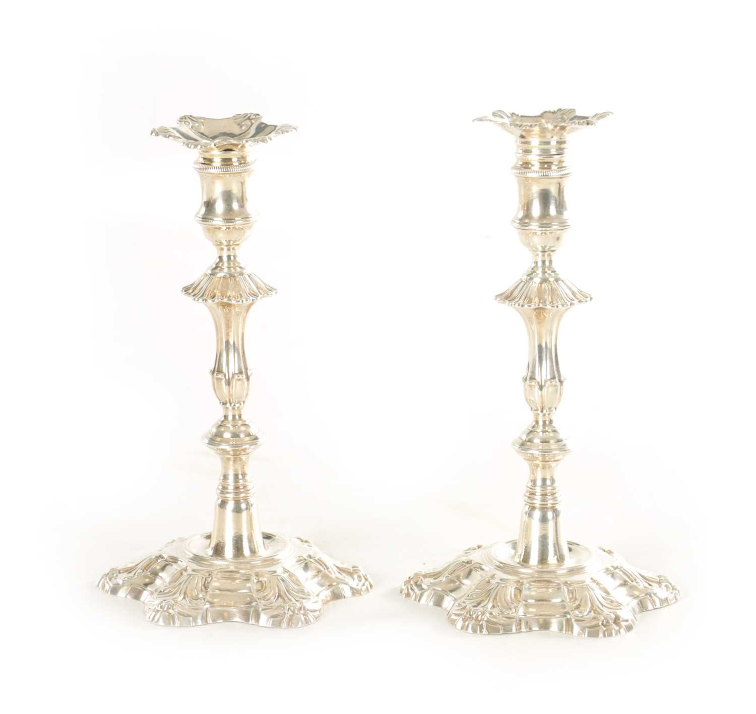 Lot 383 - A PAIR OF GEORGE II CAST SILVER PETAL BASE CANDLESTICKS