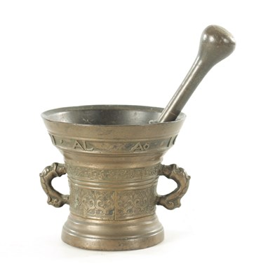 Lot 875 - AN EARLY DUTCH BRONZE PESTLE AND MORTAR INSCRIBED AND DATED 1616